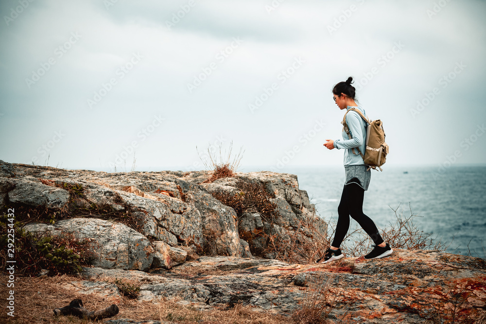 Obraz premium Young asian woman hiking at seaside mountain