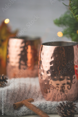 Two cups of hot drink on a Christmas background. Cold autumn. Atmosphere of home, warmth and comfort. Vertical photo.