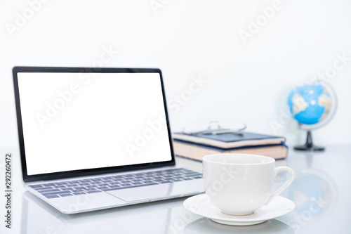 Laptop mockup and coffee cup on table