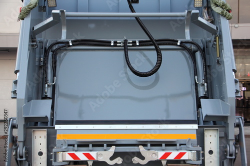 New gray refuse truck rear view close up, city cleaning