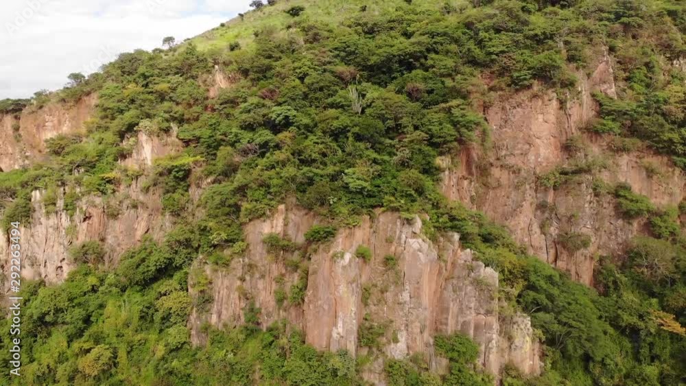 Drone shot going up a cliff and discovering the horizon at the top Drone shot going up a cliff and discovering the horizon at the top