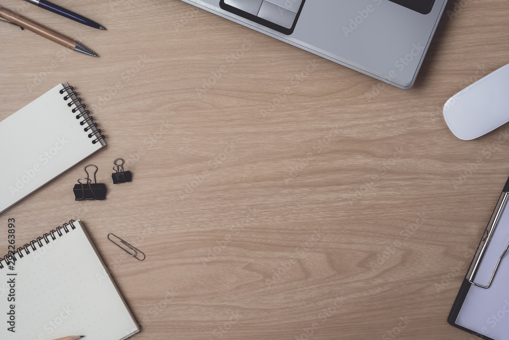 Workspace with diary or notebook and clipboard, laptop, mouse computer, keyboard, pencil, pen on wooden background Workspace with diary or notebook and clipboard, laptop, mouse computer, keyboard, pencil, pen on wooden background