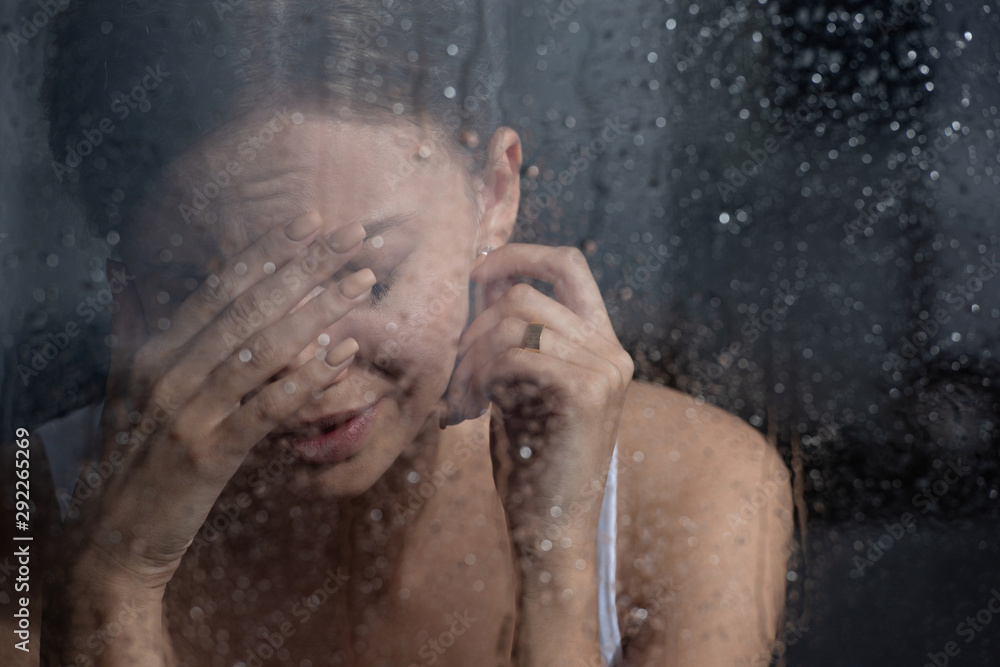 Fototapeta premium selective focus of upset young woman crying at home