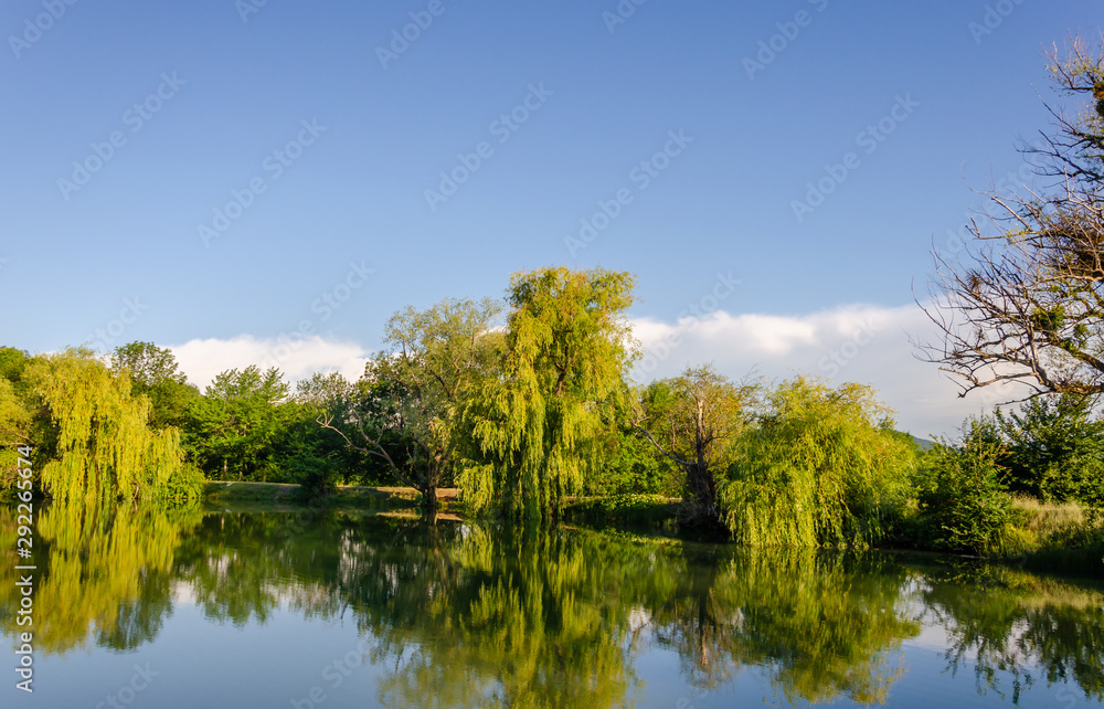 In summer, the lake is surrounded by green trees. In summer, the lake is surrounded by green trees.