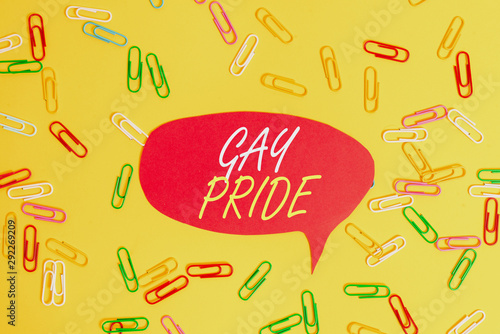 Handwriting text Gay Pride. Conceptual photo Dignity of an idividual that belongs to either a analysis or woanalysis Flat lay above empty paper with copy space and colored paper clips photo