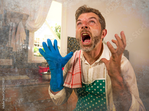 Photos dramatic grunge portrait of  house husband or single man in kitchen apron doing