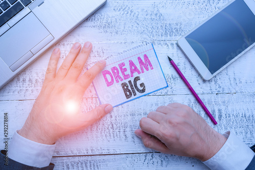 Conceptual hand writing showing Dream Big. Concept meaning To think of something high value that you want to achieve photo