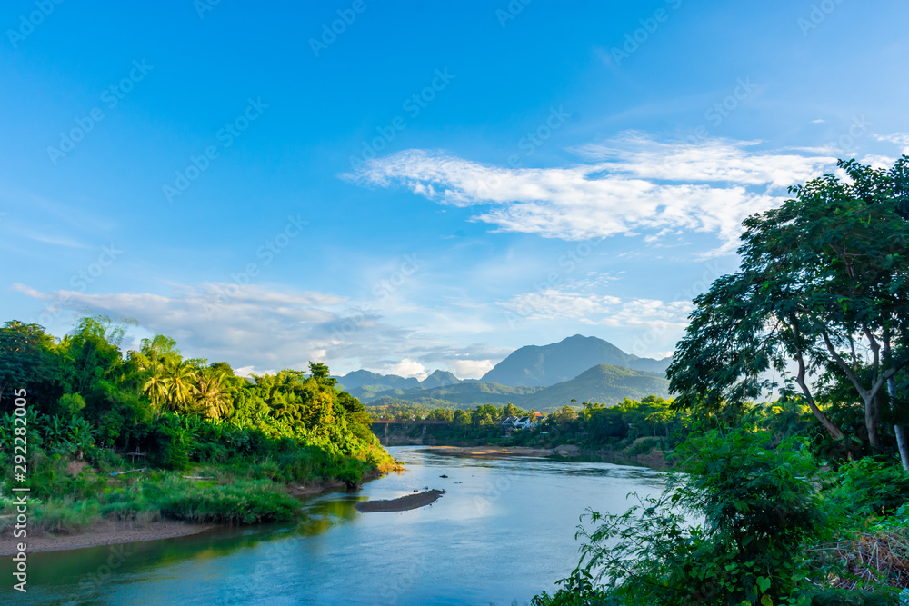 Beautiful green hills landscape and rivers on blue sky background. decoration image contain certain grain noise and soft focus.