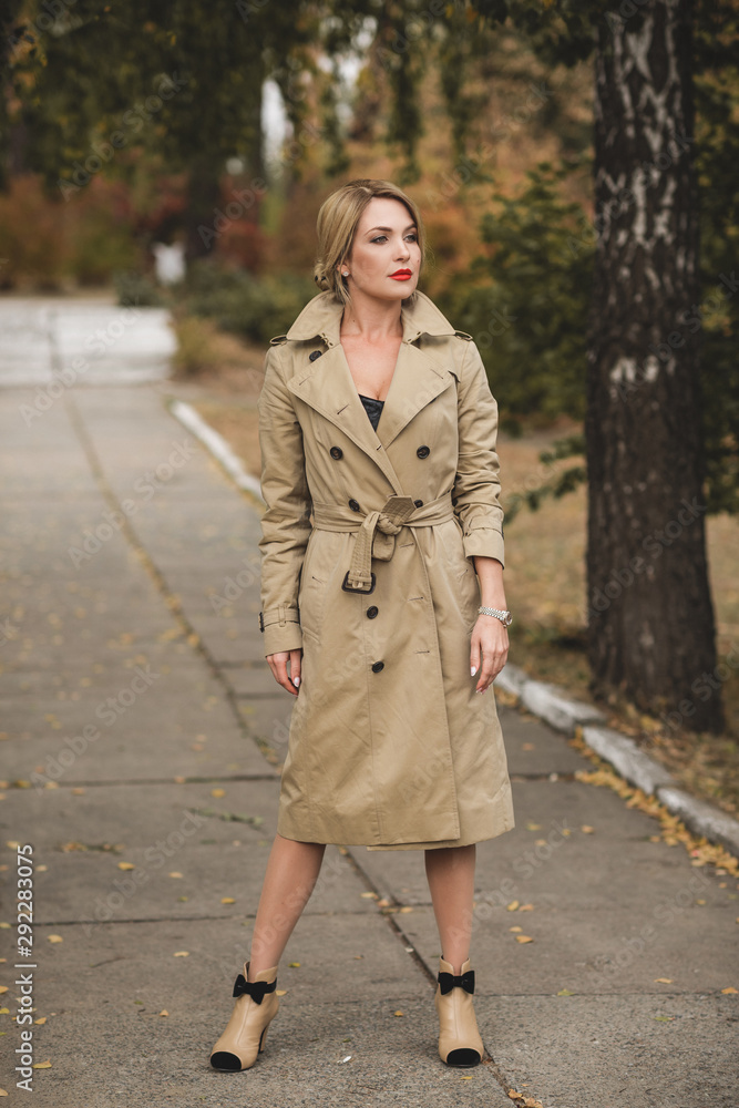 Autumn golden time, portrait of fashionable woman wear beige coat , scene at park outdoors