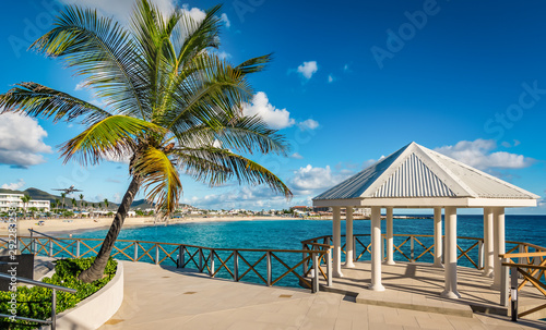 Fototapeta Naklejka Na Ścianę i Meble -  Romantic pavilion and palm tree on St Maarten Island. Maho bay beach background.