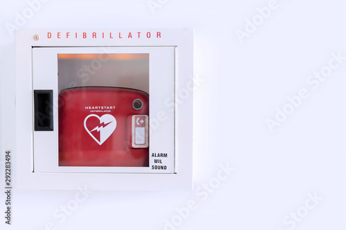 Automated External Defibrillator (AED) in white box on the wall Is an emergency pacemaker device for people with cardiac arrest. Heart defibrillator on white background.