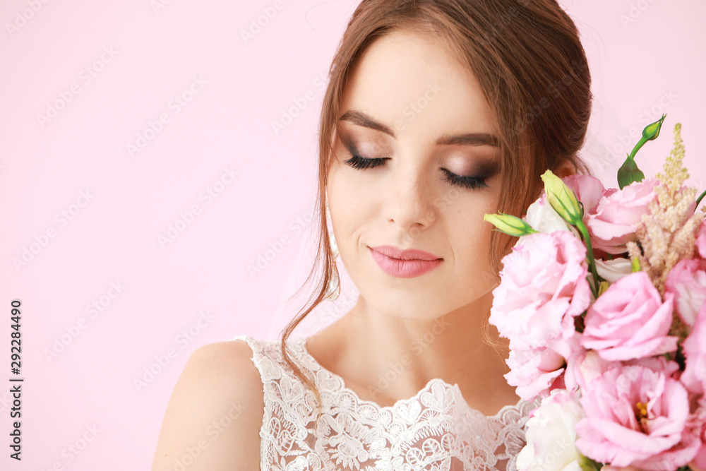Portrait of beautiful young bride with wedding bouquet on color background Portrait of beautiful young bride with wedding bouquet on color background