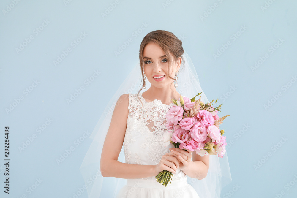 Portrait of beautiful young bride with wedding bouquet on light background Portrait of beautiful young bride with wedding bouquet on light background