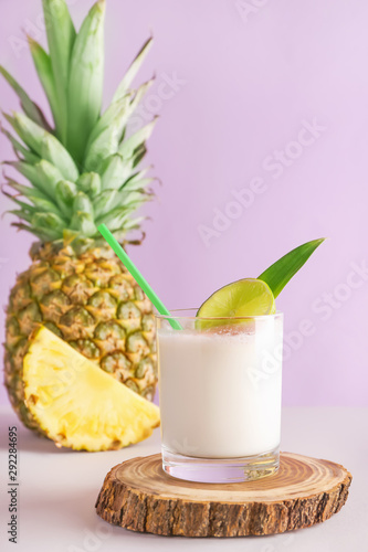 Glass of tasty Pina Colada cocktail on table