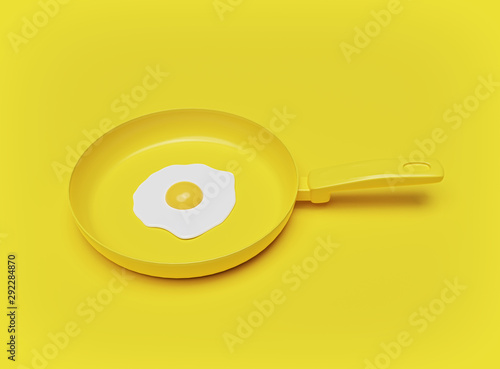 Vászonkép Fried egg in a frying pan on yellow background