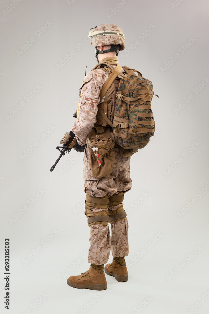 Rear view of military soldier US army marines operator studio shot portrait Rear view of military soldier US army marines operator studio shot portrait