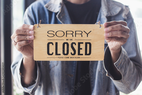 Close up sign hanging off Coffee shop door,Close sign blur background,Label word close