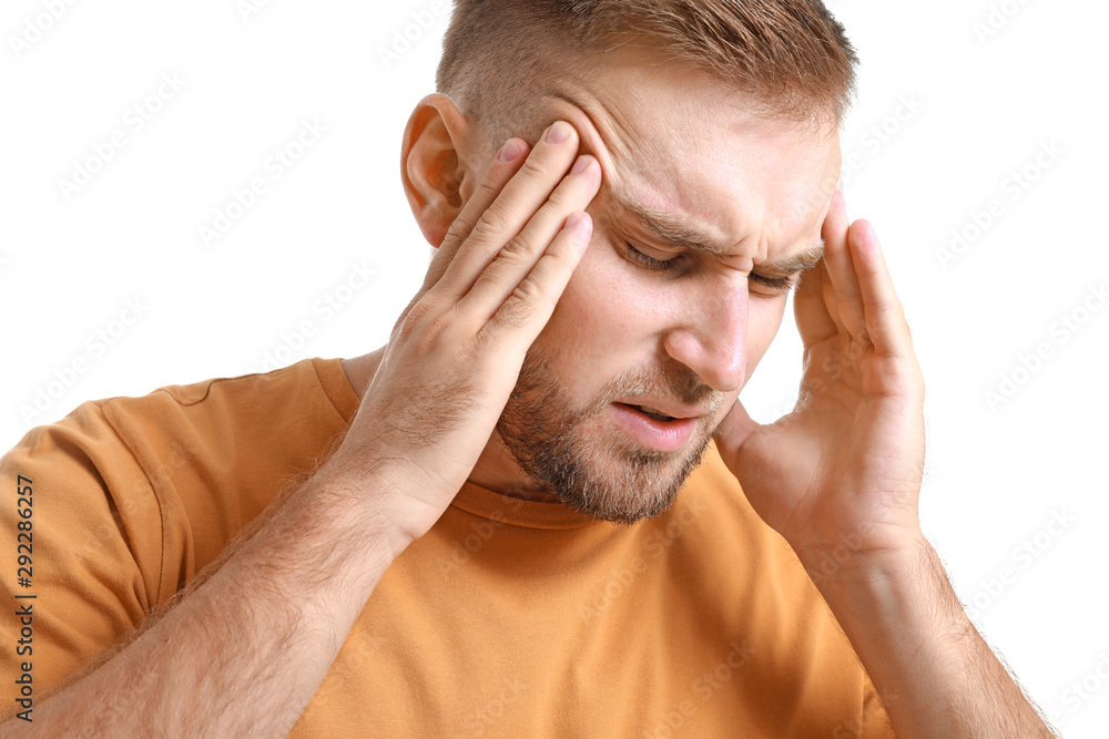 Young man suffering from headache on white background Young man suffering from headache on white background