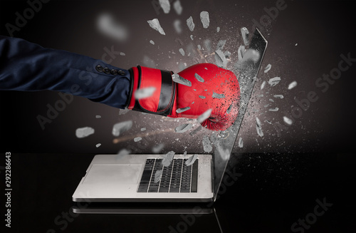 Strong male hand breaks laptop screen © ra2 studio