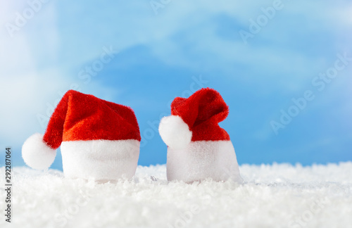 Two Santa hats in the snow