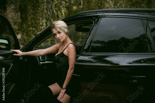 Gorgeous woman with a car, luxury style, concept lady and automobile 