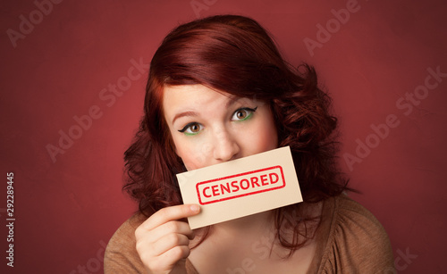 Young person holding adult content card in hand
