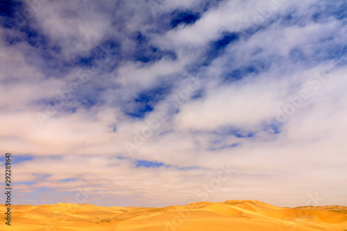 Blue sky with sand dune. Landscape in Namibia, Africa. Travelling in the desert. Yellow sand hills. Namib Desert, sand dune mountain with beautiful blue sky with white clouds.