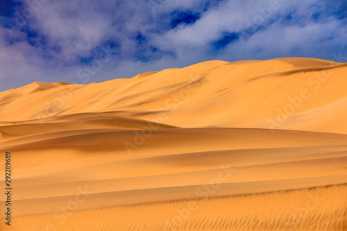 Landscape in Namibia, Africa. Travelling in the Namibia desert. Yellow sand hills. Namib Desert, sand dune mountain with beautiful blue sky with white clouds.