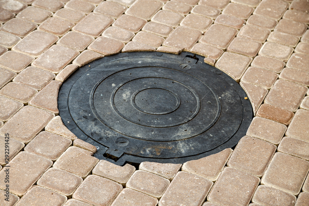 Old rusted metal gutter for rain water on the stone paved sidewalk. Old rusted metal gutter for rain water on the stone paved sidewalk.