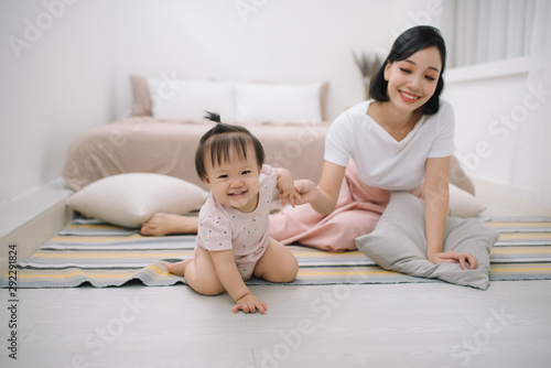 asian mother and child relaxing on the bed room