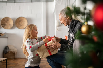 Girl unpacking christmas gift