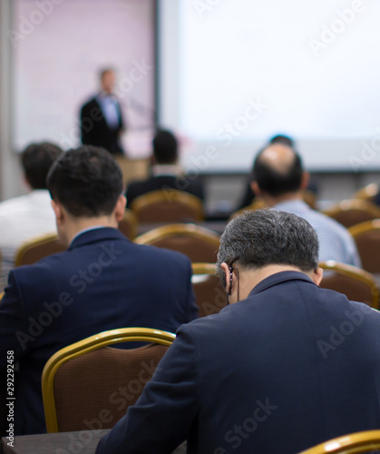 Conference photo audience and tech speaker giving speech. Seminar presenter at CEO forum. Corporate manager in executive training discussion on stage. Investor pitch presentation workshop picture.
