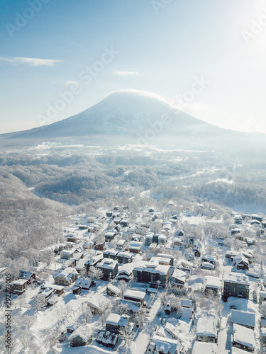 Winter in Niseko, Japan. A blue bird kind of day at Grand Hirafu, Niseko Ski Resort. Photos were taken with a drone overlooking the Grand Hirafu area with views of Mt. Niseko-Annupuri. and Mt. Yotei.