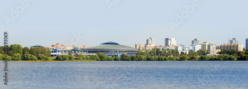 River Svisloch in Minsk, Belarus, Chizhovka Arena and park, city skyline. Summer landscape, panoramic view