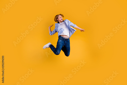 Full body photo of crazy redhead guy jumping high making slam dunk trick best basketball team player final cup game wear casual outfit isolated yellow background