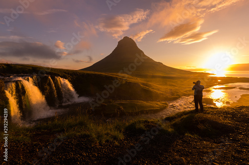 Silhouette of Photographer taking photo Kirkjufellsfoss at morning