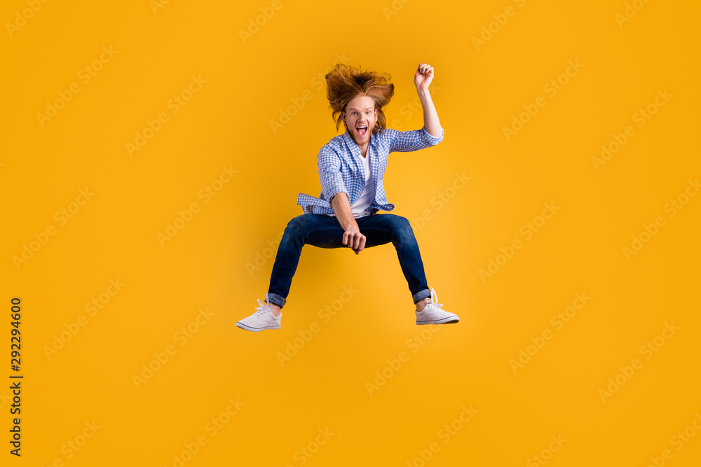 Full length body size photo of cheerful crazy excited horse rider wearing jeans denim checkered blue shirt approaching jumping isolated over vivid color background