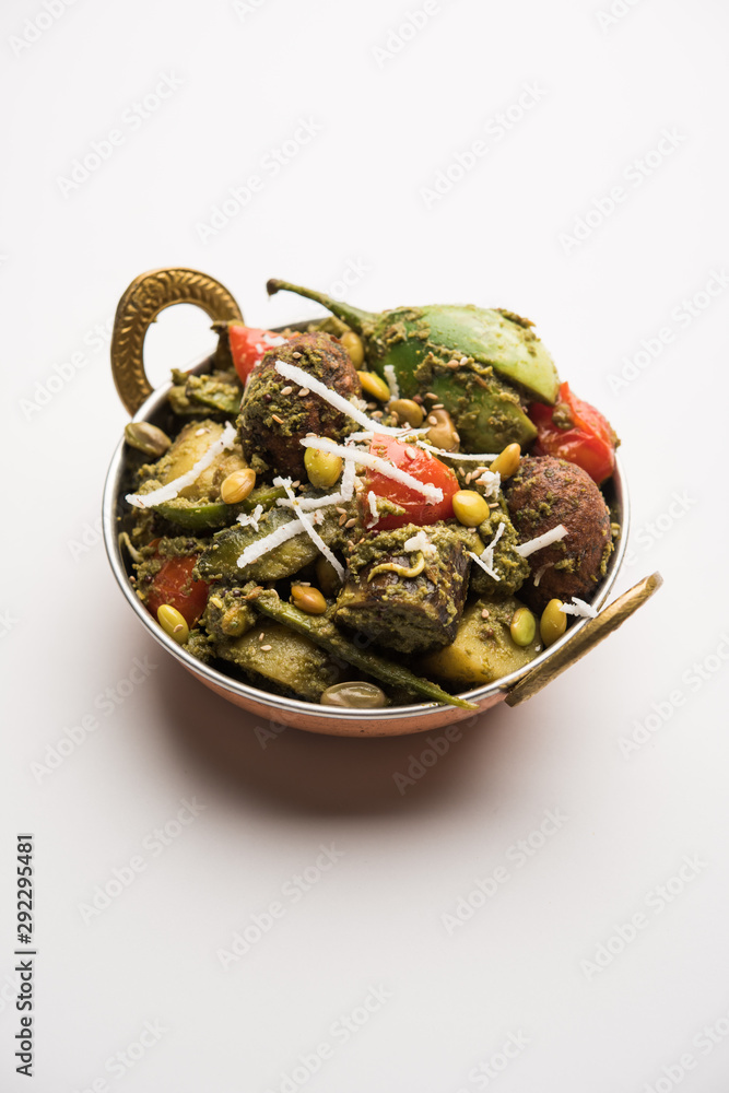 Undhiyu is a Gujarati mixed vegetable dish, specialty of Surat, India. Served in a bowl with or without poori Undhiyu is a Gujarati mixed vegetable dish, specialty of Surat, India. Served in a bowl with or without poori
