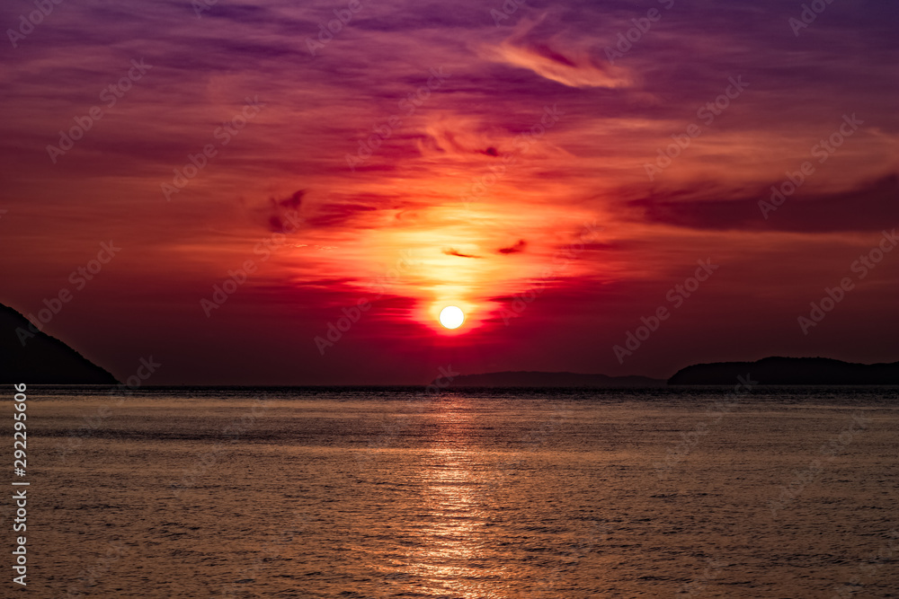 A vibrant sunrise from the pier in Rawai, Thailand