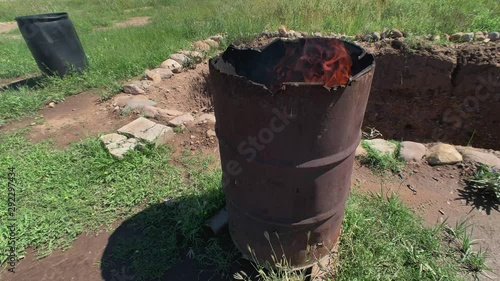Burning Trash In Old Rusty Barrel. photo
