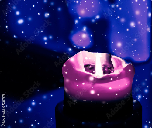 Canvas Print Pink holiday candle on blue sparkling snowing background, luxury branding design
