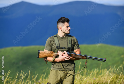 Security. military style. male in camouflage. army forces. sniper reach target mountain. man ready to fire. hunter hobby. muscular man hold weapon. purpose and success. soldier in the field. polygon