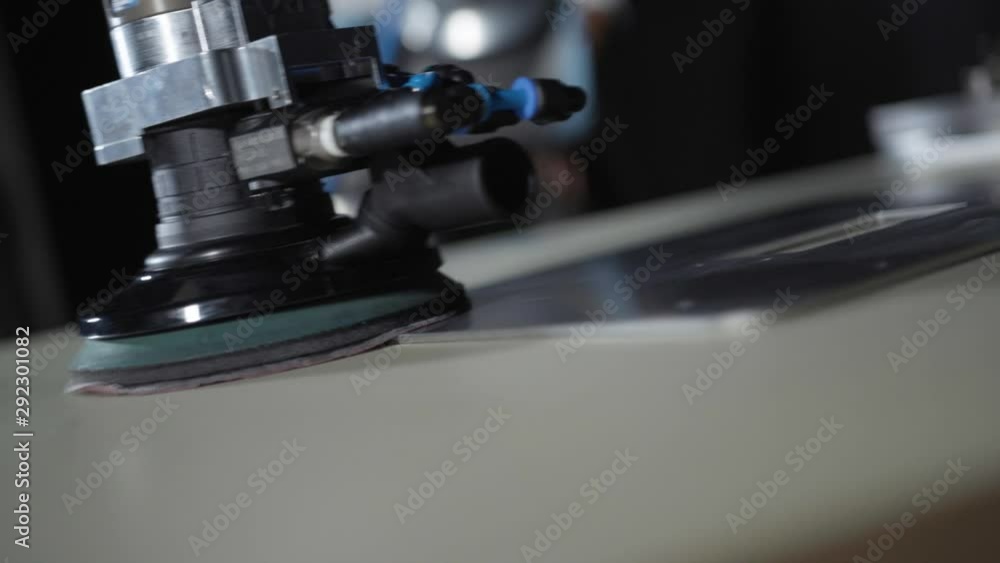 Close up shot of a robotic arm's end polishing a piece of metal Close up shot of a robotic arm's end polishing a piece of metal