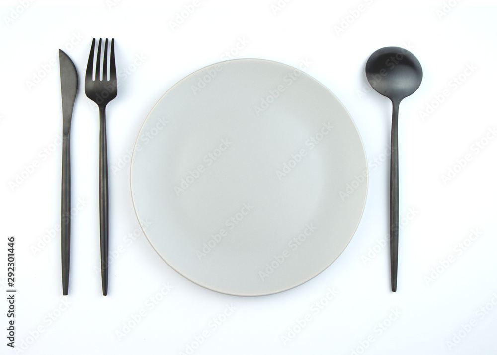 Empty plate and modern cutlery isolated on white background. Stylish setting. Empty plate and modern cutlery isolated on white background. Stylish setting.