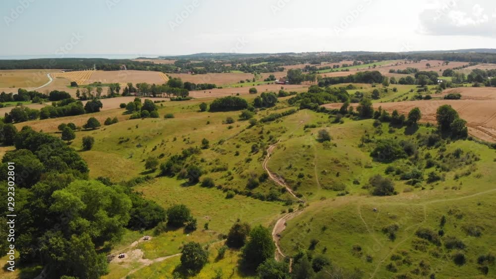Aerial view over the idyllic Swedish hills Brosarps backar on Osterlen in Skane, Sweden. Open fields and hiking trails Aerial view over the idyllic Swedish hills Brosarps backar on Osterlen in Skane, Sweden. Open fields and hiking trails