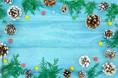 Top view winter frame blue shabby Christmas border with snow-covered pinecones with branches and decorations