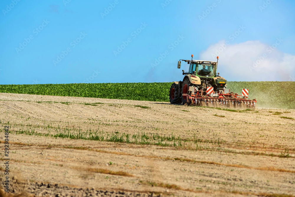 Fototapeta premium nice view of a farmer plowing his fields