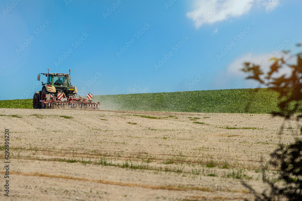 Fototapeta premium nice view of a farmer plowing his fields