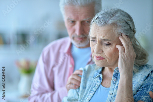 Close up portrait of sad senior couple posing