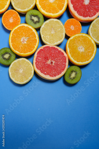 Fresh summer fruits on blue background.